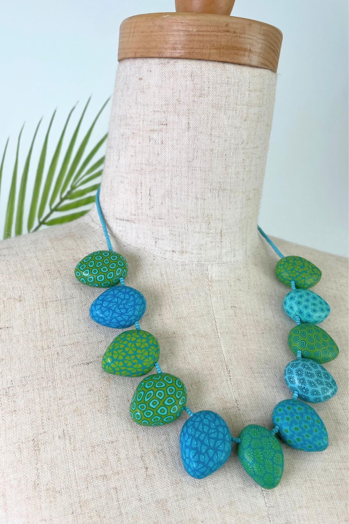 Fair trade polymer clay necklace made in Nepal – intricate filigree designs / blue and green colours