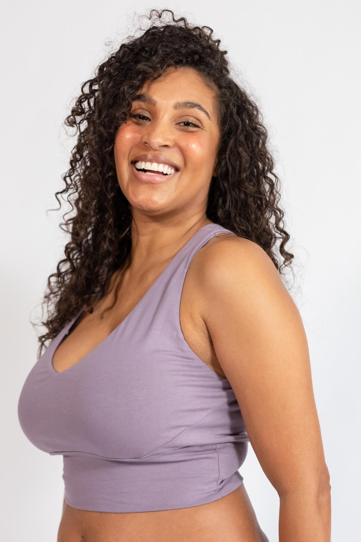 Woman wearing a purple sports bra on a white background