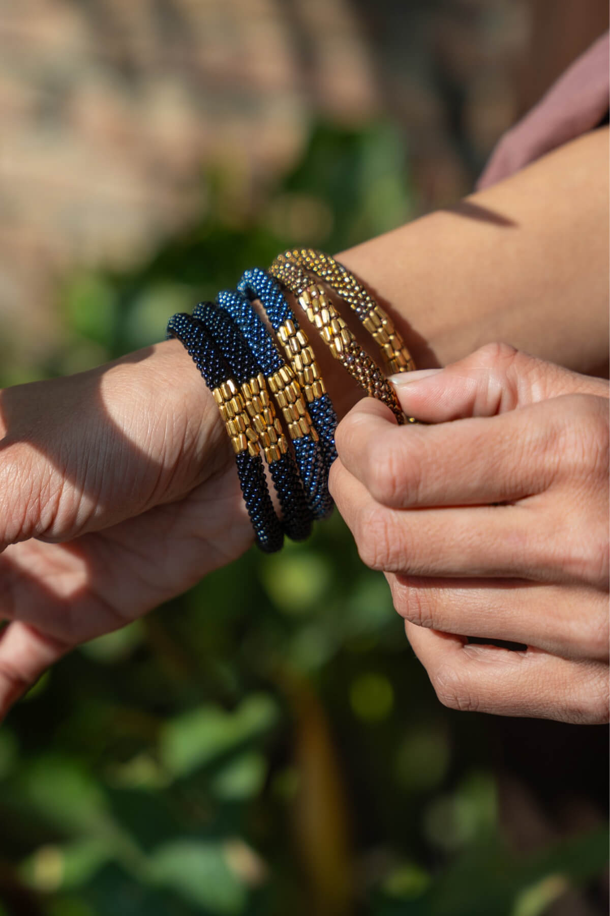 Ethical roll-on beaded bracelets made in Nepal - with gold coloured contrasting flat beads