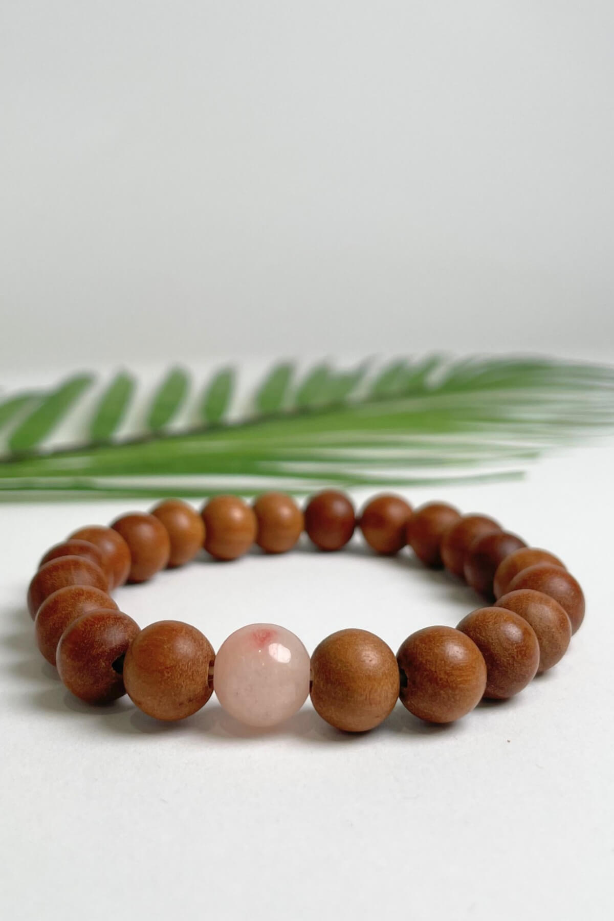 Sandalwood bracelets ethically made in Nepal - rose pink colour stone