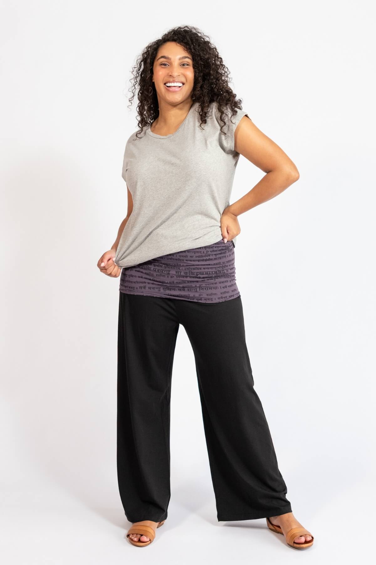 Woman wearing black turn over waist pants