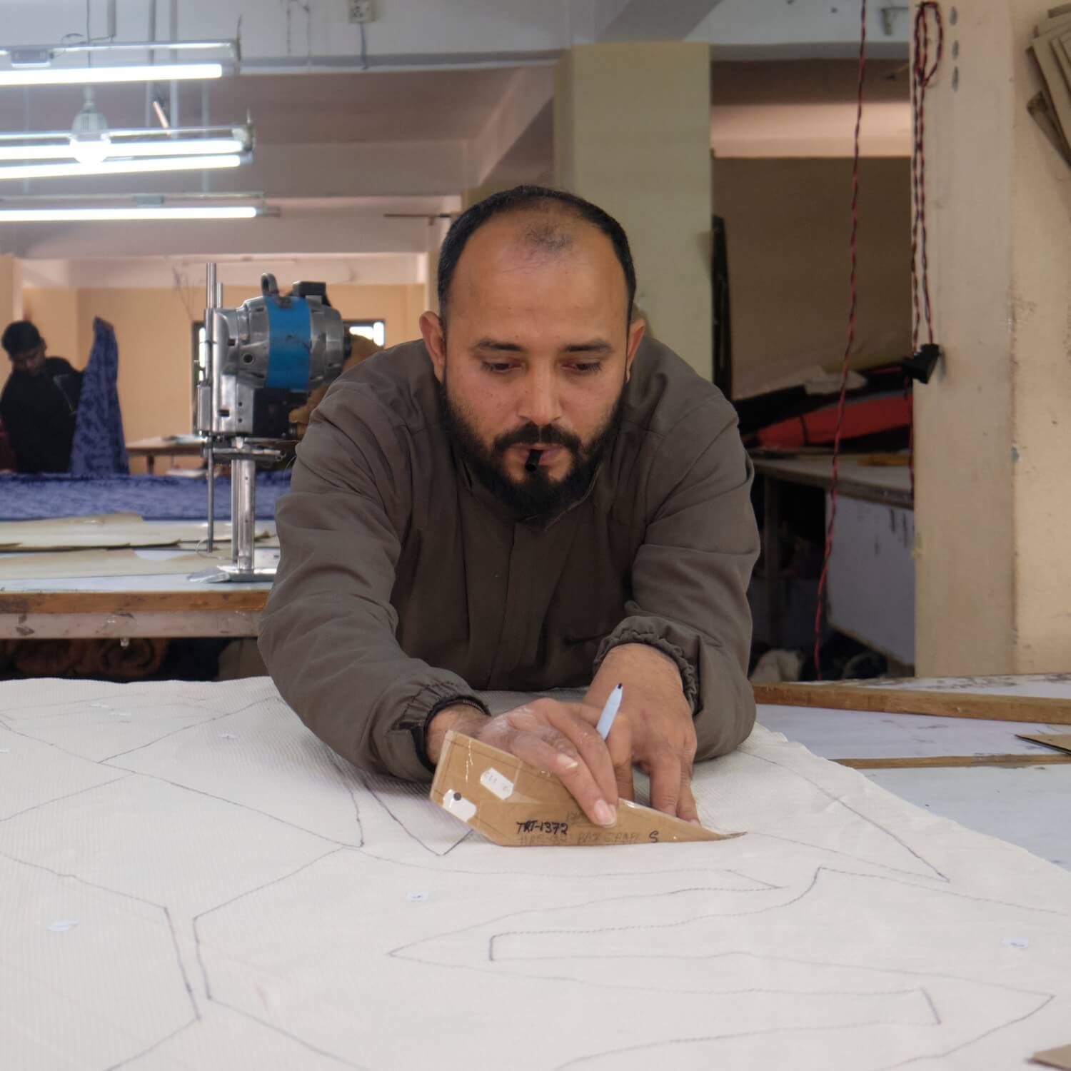 Surya Ethical Clothing Production in Nepal - drawing the pattern onto fabric